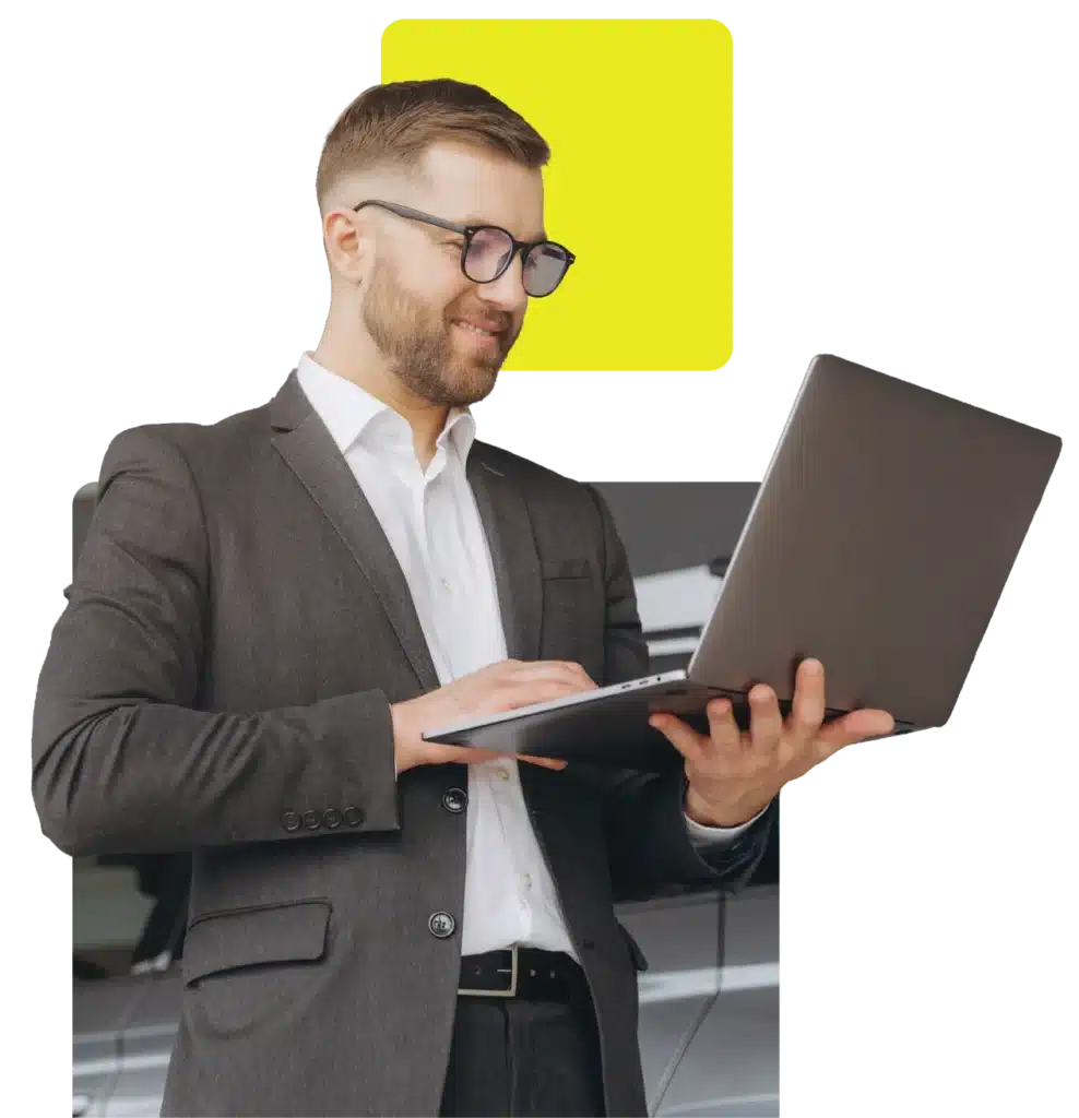 car retailer checking his automotive finance platform on a laptop