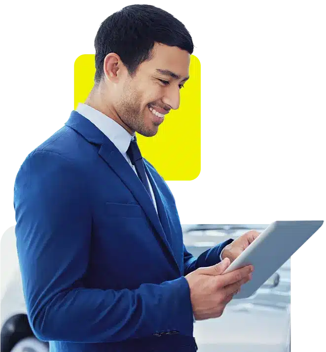 car dealer using his ipad to manage finance for his dealership