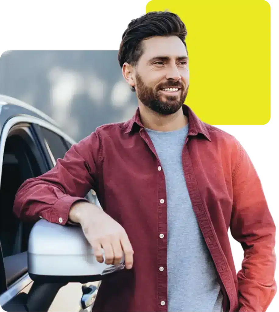 Man looking happy next to the car he bought on finance through an auto finance broker