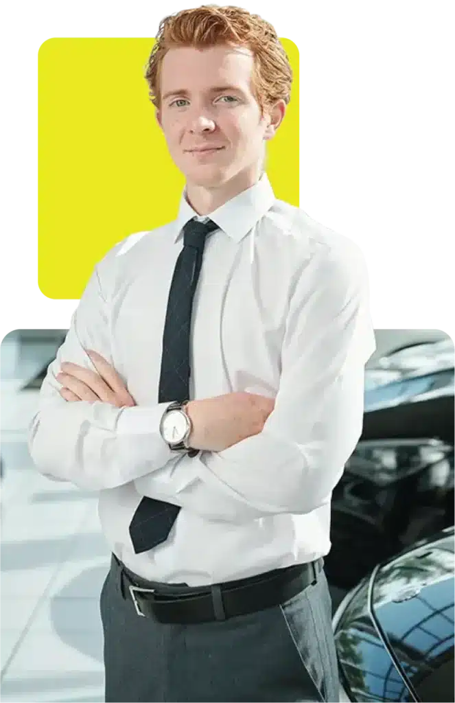 male car dealer standing in front of his showroom car on finance