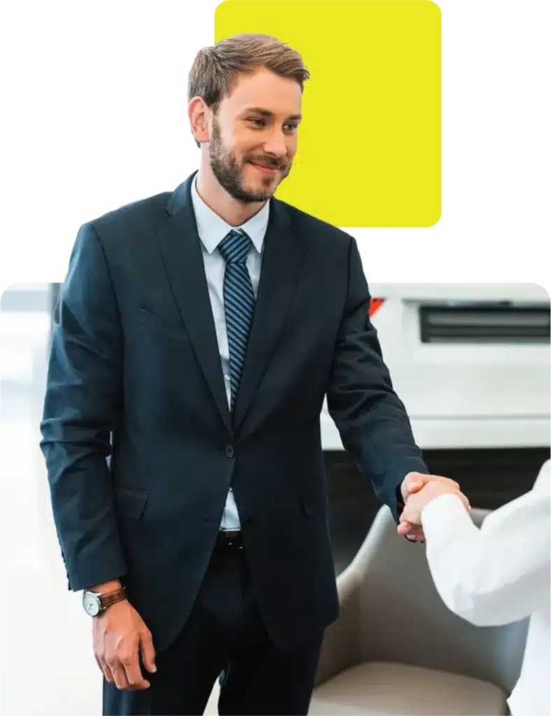 dealer greeting a customer in the car showroom