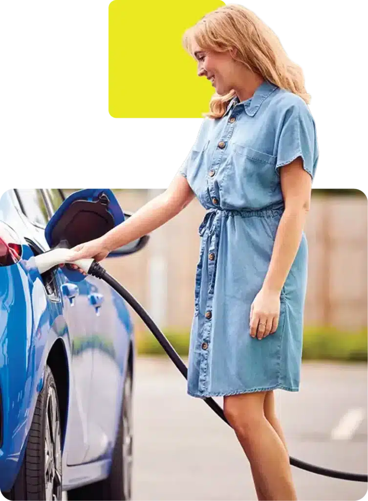 Lady charging electric vehicle bought through evolution funding using ev finance